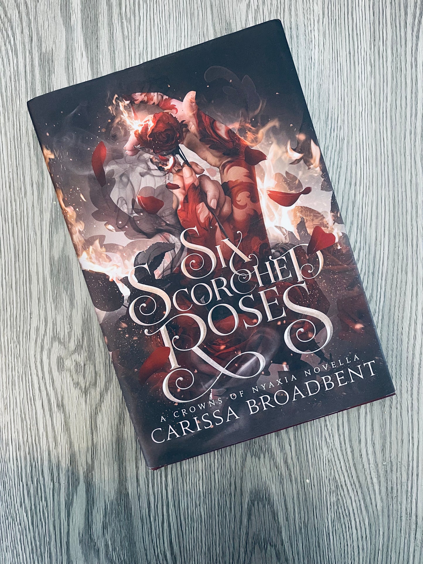 Six Scorched Roses (Crowns of Nyaxia #1.5) by Carissa Broadbent - Hardcover Used